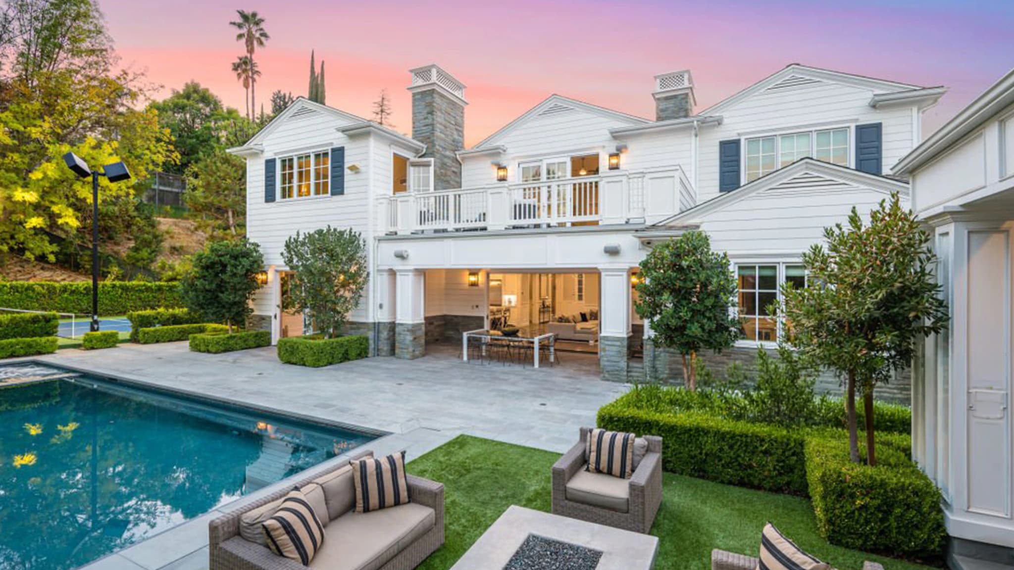 Private estate with pool and landscaped garden at dusk